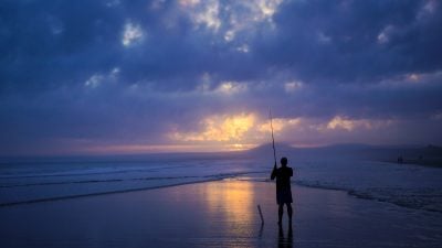 Fisherman using fishing rod