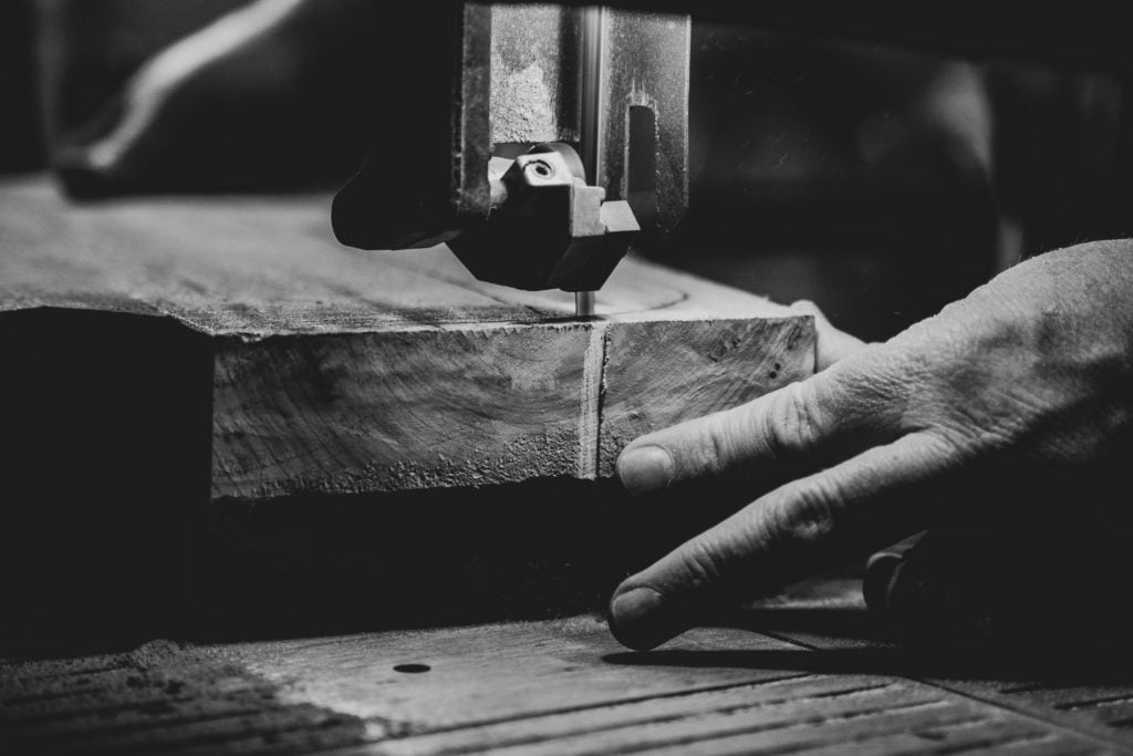 Close-up image of a man making a piece of luxury furniture