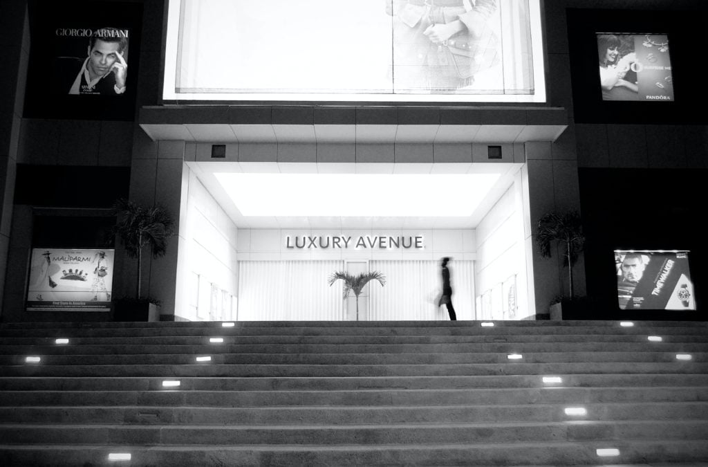 A silhouetted figure walking across a luxury shop entitled 'Luxury Avenue'